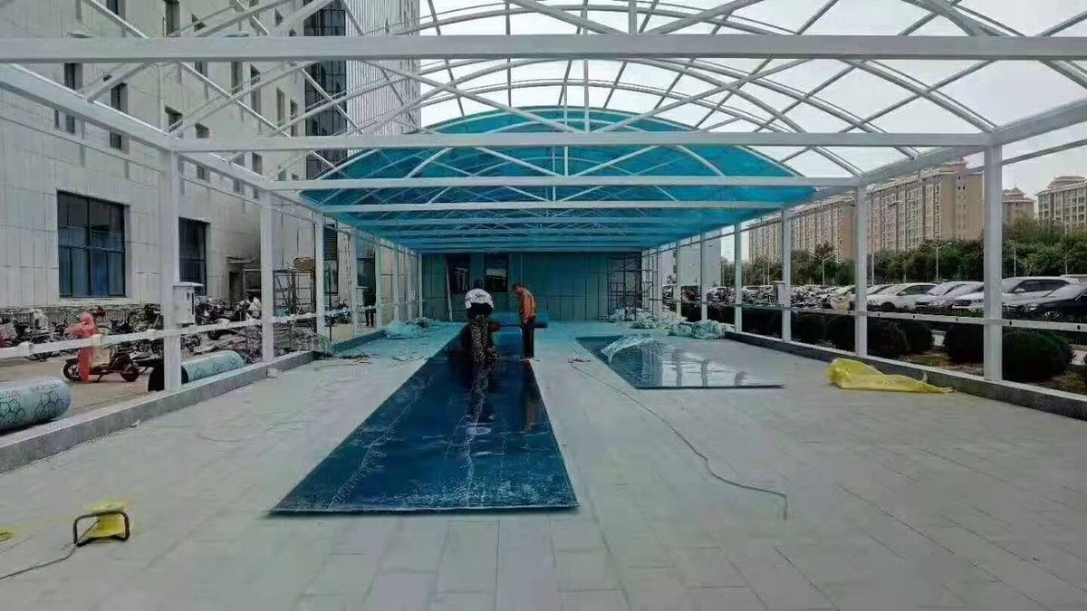 Outdoor canopy structure featuring solid polycarbonate panel installation