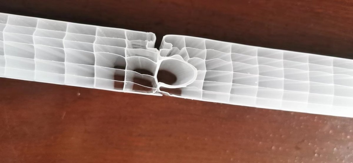 Close-up of interlocking tongue-and-groove mechanism on polycarbonate panel edge for easy balcony screen installation