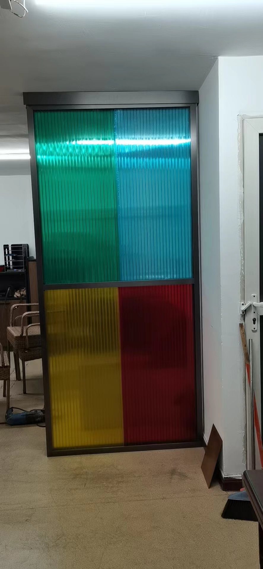 Colorful interlocking polycarbonate panels used as decorative facade partition showing modern architectural application for balcony privacy
