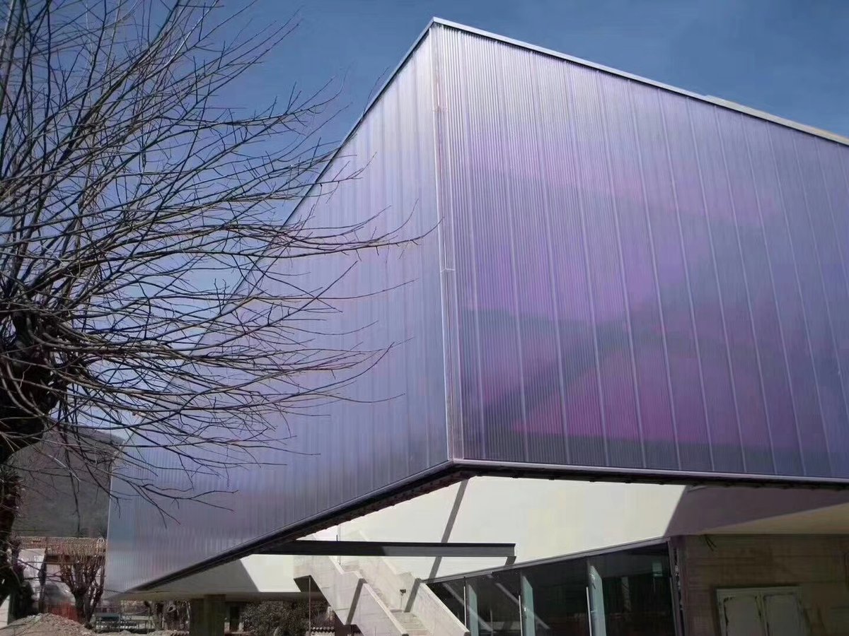 Modern building facade using translucent polycarbonate interlocking panels as curtain wall cladding system