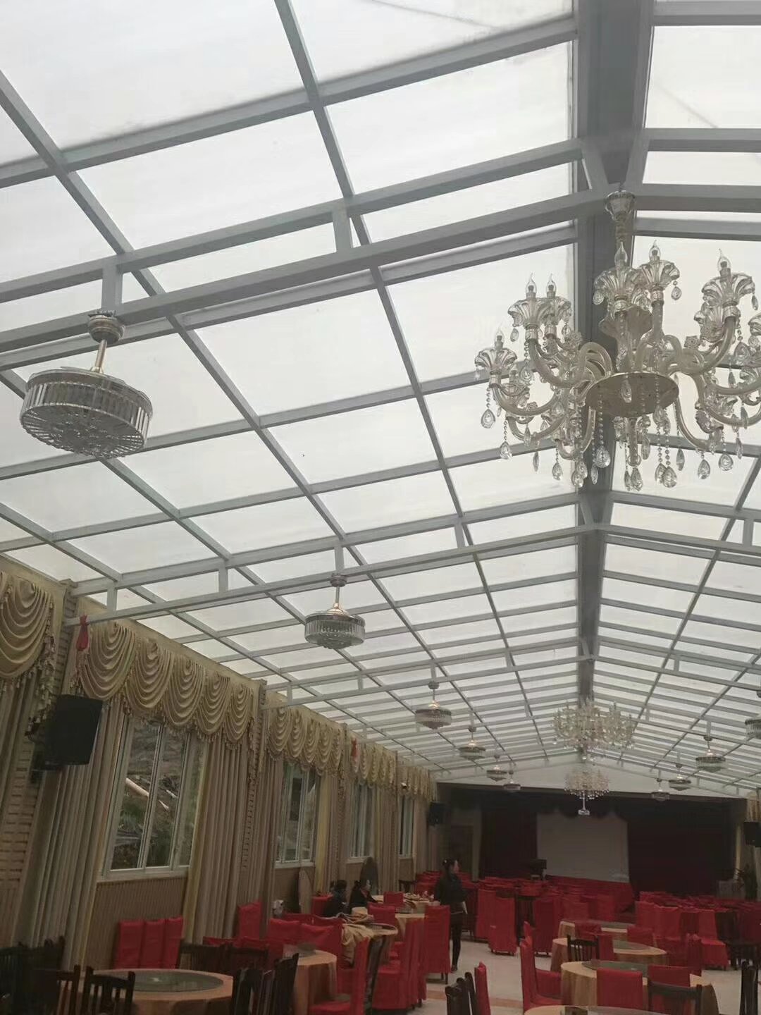 Eco-restaurant banquet hall with polycarbonate skylight ceiling and elegant chandeliers