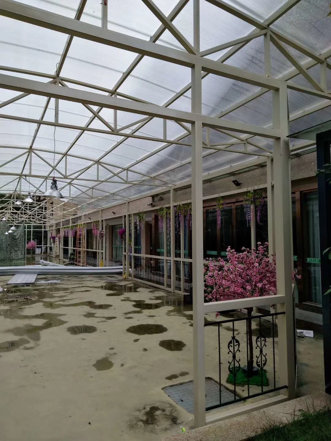 Completed U-Lock polycarbonate skylight roof installation on an industrial factory building showing the large-span transparent roof panels with metal support structure