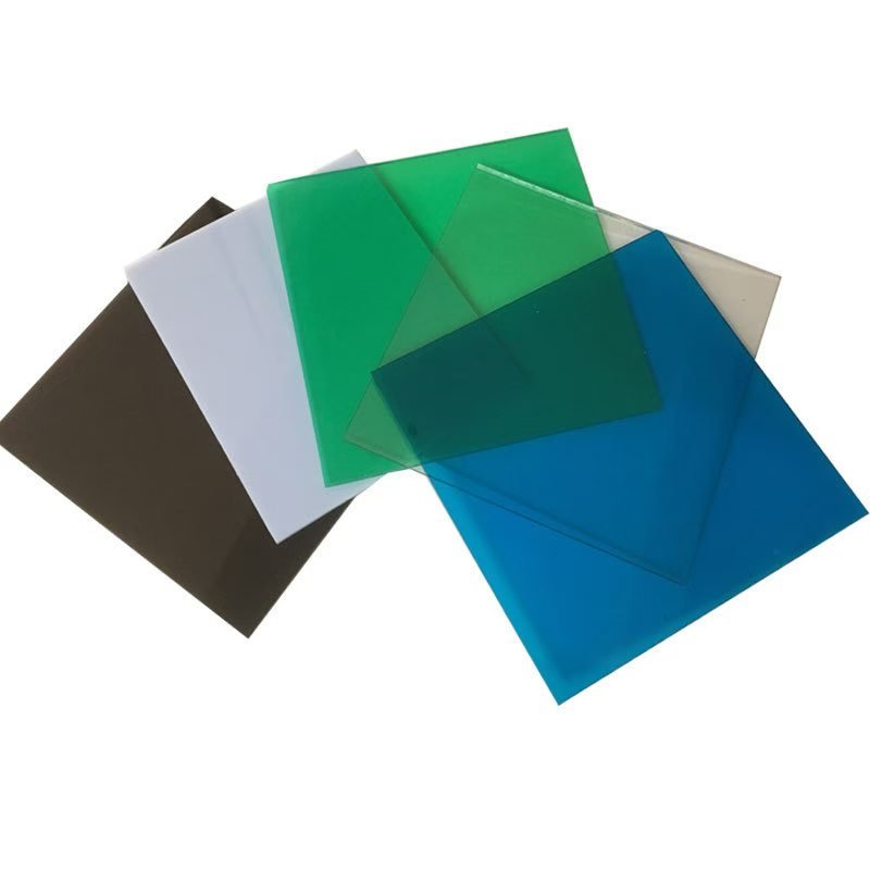Solid polycarbonate sheets in clear, blue, green, opal white, and bronze showing different light transmission levels