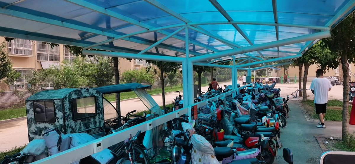Multiwall polycarbonate sheet canopy over a covered parking shelter