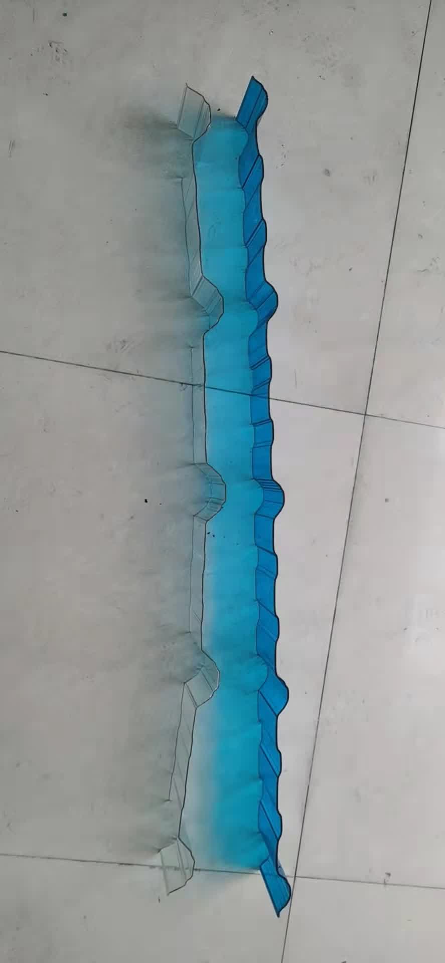 Blue-tinted corrugated polycarbonate sheet in product display showing color variation and wave structure