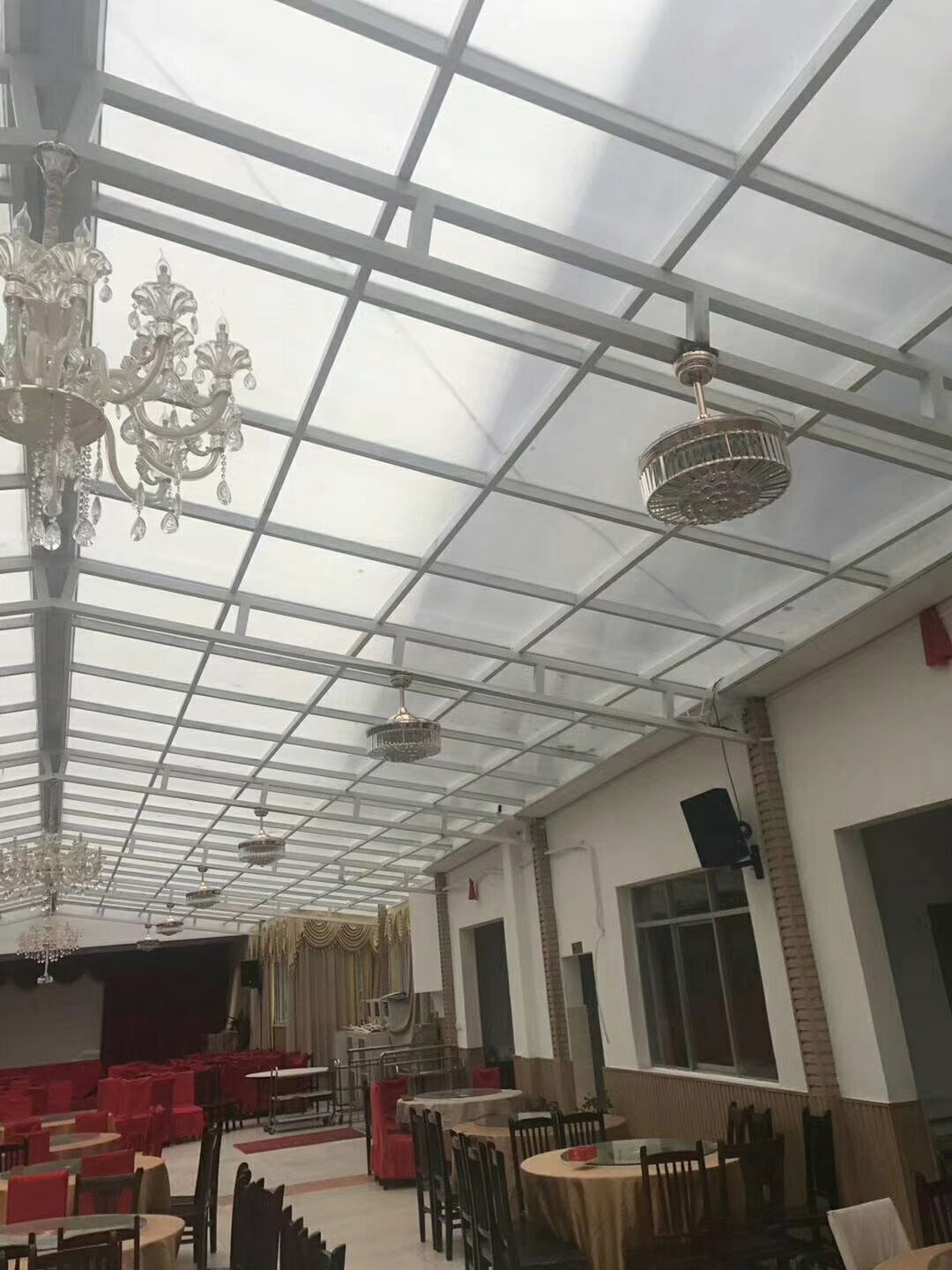 Diffused daylight through an opal solid polycarbonate ceiling in a banquet hall