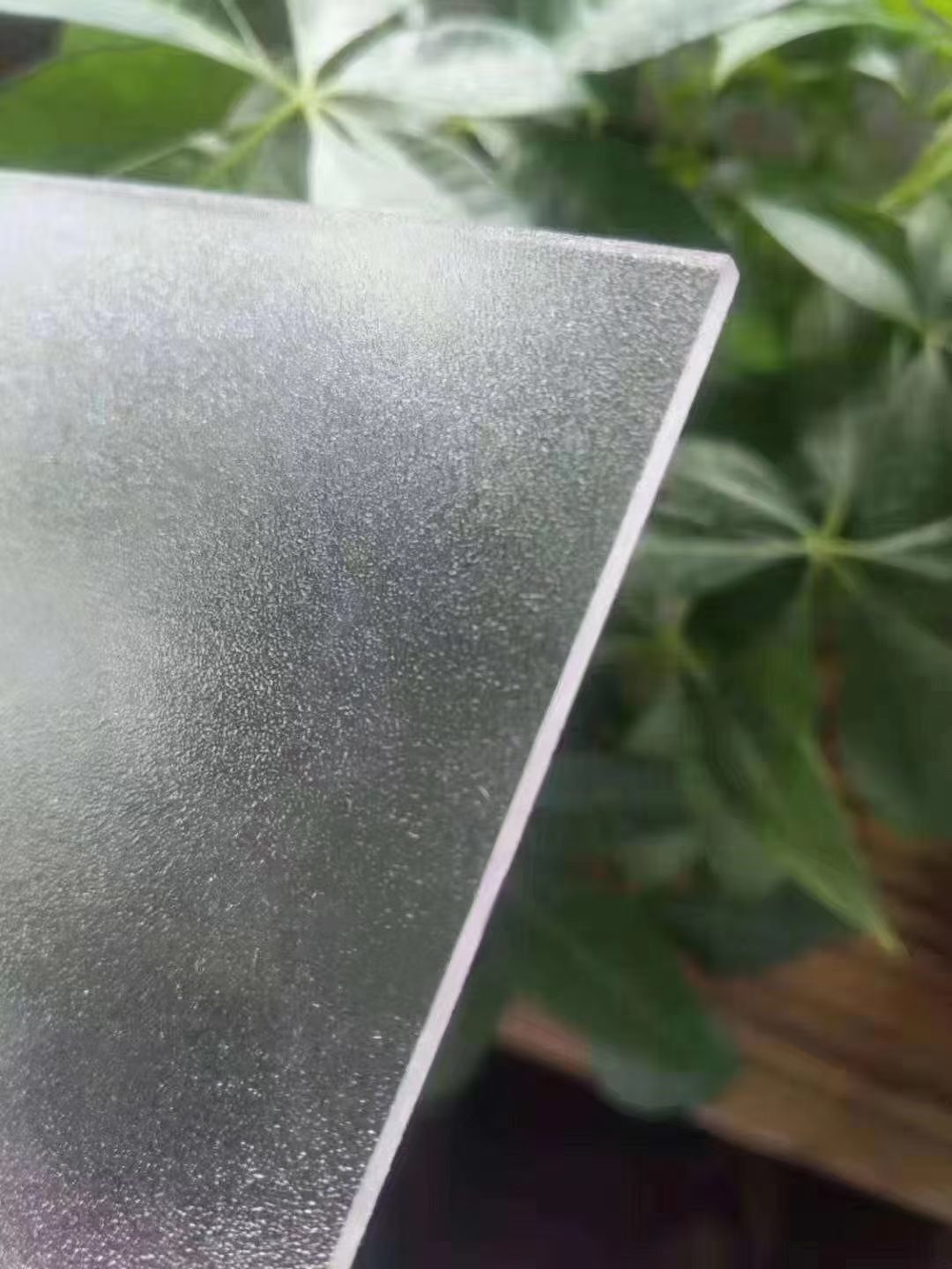Edge of a frosted polycarbonate sheet showing sheet thickness and matte finish