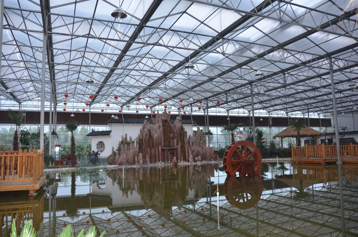 Clear multiwall polycarbonate roof over an indoor garden landscape in a 10,000 square meter ecological park