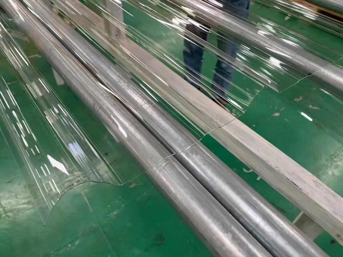 Stacked transparent corrugated polycarbonate sheets ready for installation