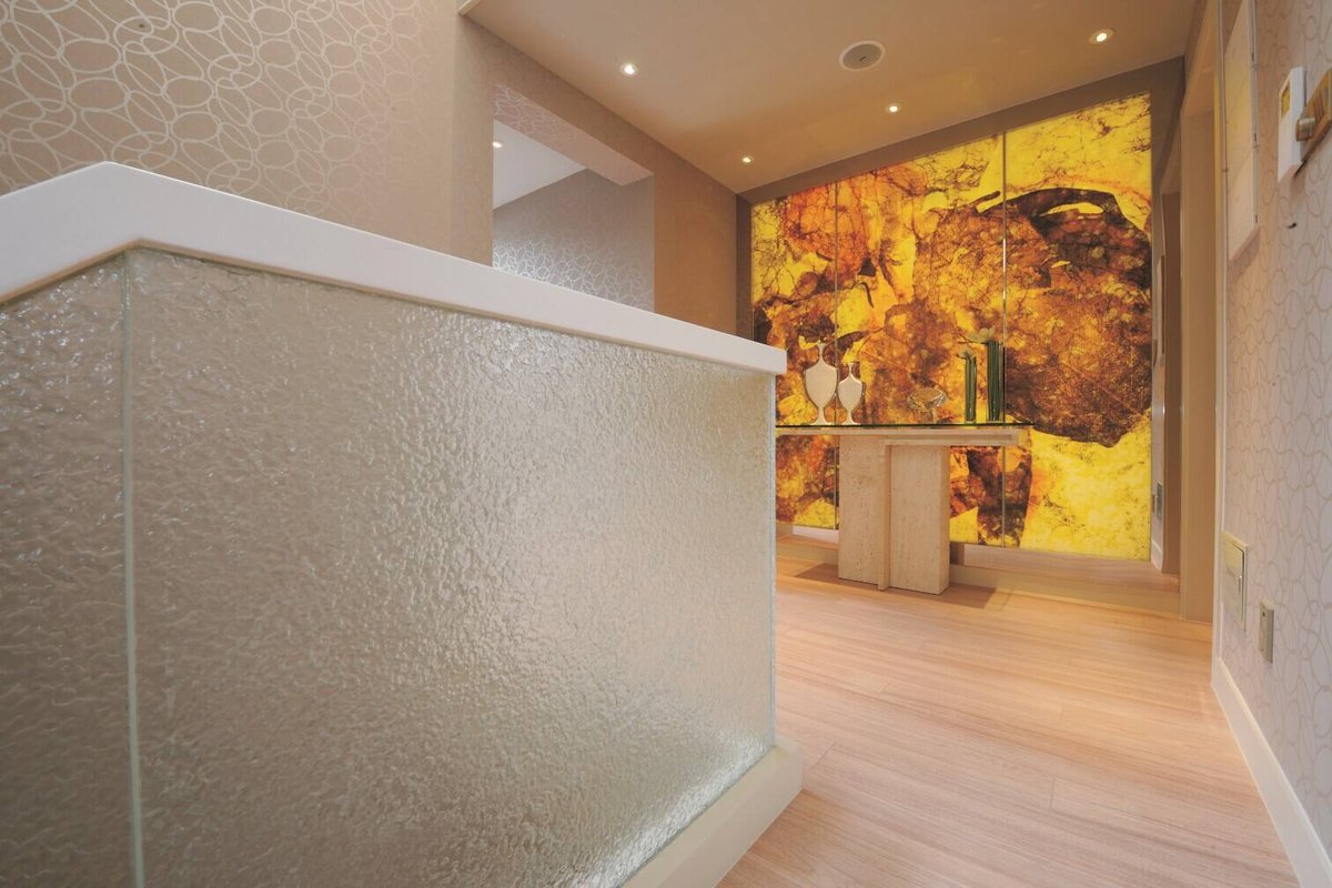 Textured polycarbonate panel used as a translucent room divider in an interior