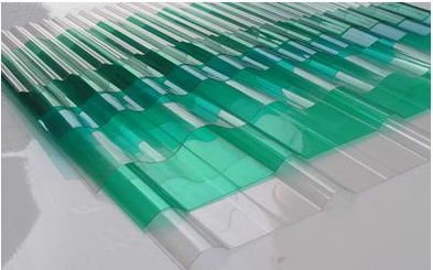 Green translucent corrugated polycarbonate sheet with a wavy profile on a clean white background